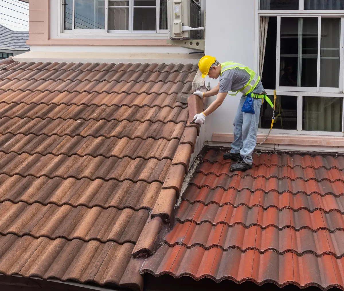 Man in safety gear on roof