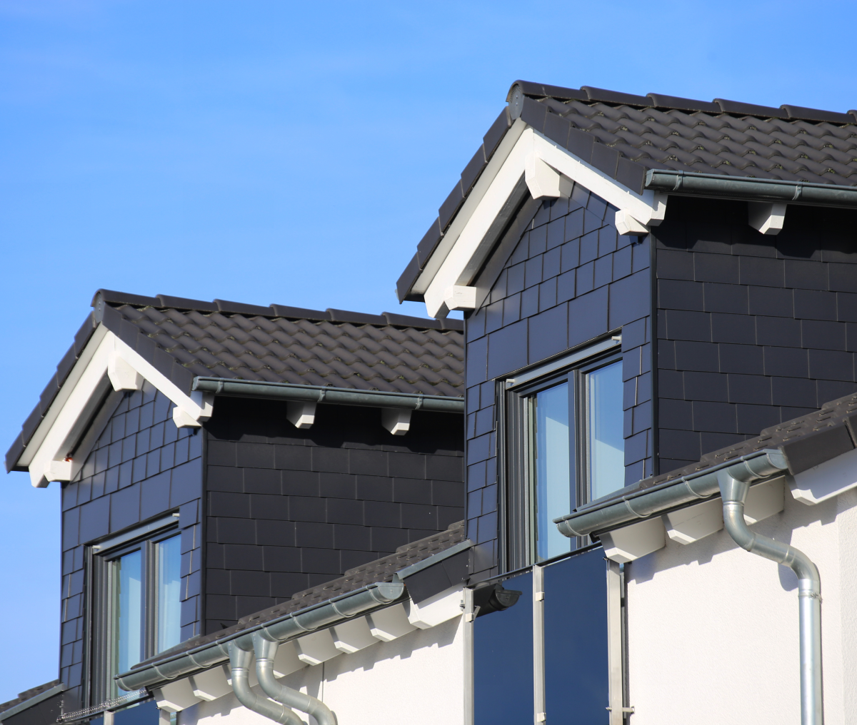 Residential building with dark roof shingles